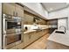 Modern kitchen with double ovens and stainless steel appliances at 9930 E Miramonte Dr, Scottsdale, AZ 85262