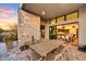 Covered patio with dining table and chairs, adjacent to kitchen at 9930 E Miramonte Dr, Scottsdale, AZ 85262