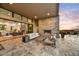 Outdoor patio with fireplace and seating area, offering sunset views at 9930 E Miramonte Dr, Scottsdale, AZ 85262