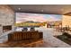 Expansive patio with fireplace, seating area, and pool access at 9930 E Miramonte Dr, Scottsdale, AZ 85262