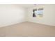 Bright bedroom with neutral carpeting and large window at 17798 W Coolidge St, Goodyear, AZ 85395