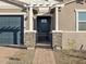 Front entrance with a dark-colored door and stone accents at 17798 W Coolidge St, Goodyear, AZ 85395