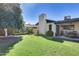 Landscaped backyard with grassy area, mature tree and patio at 19219 N 33Rd Ave, Phoenix, AZ 85027