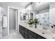 Bathroom with double vanity, shower/tub combo, and updated fixtures at 19219 N 33Rd Ave, Phoenix, AZ 85027