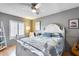 Bedroom with queen-size bed, window shutters, and a guitar at 19219 N 33Rd Ave, Phoenix, AZ 85027