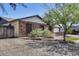 Charming single-story brick home with desert landscaping, mature trees, and an adjacent two-car garage at 19219 N 33Rd Ave, Phoenix, AZ 85027
