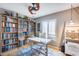 Home office features built-in bookshelves and a spacious desk area at 19219 N 33Rd Ave, Phoenix, AZ 85027