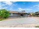 Inviting backyard with covered patio, mature trees, and space for outdoor activities at 3425 W Acoma Dr, Phoenix, AZ 85053