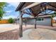 Backyard view showcasing a gazebo with chandelier, stone patio, and the home's exterior with access to a covered patio at 3425 W Acoma Dr, Phoenix, AZ 85053