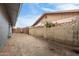 View of the backyard of this home, showing a stone wall and gravel at 3425 W Acoma Dr, Phoenix, AZ 85053