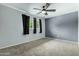 Cozy bedroom featuring grey walls, carpeted floors, and windows, creating a serene and comfortable living space at 3425 W Acoma Dr, Phoenix, AZ 85053