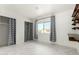 Bright bedroom with patterned curtains, closet, and a desk area, creating a functional living space at 3425 W Acoma Dr, Phoenix, AZ 85053