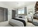 Stylish bedroom with patterned curtains, closet, and a desk area, creating a comfortable and functional living space at 3425 W Acoma Dr, Phoenix, AZ 85053