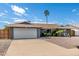 Attractive single-story home showcasing desert landscaping and a wide driveway leading to an attached two-car garage at 3425 W Acoma Dr, Phoenix, AZ 85053