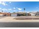 Attractive single-story house showing desert landscape and a wide driveway leading to attached two-car garage at 3425 W Acoma Dr, Phoenix, AZ 85053