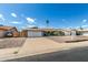 Lovely single-story home showcasing a two-car garage, desert landscaping, and a cozy seating area in the front yard at 3425 W Acoma Dr, Phoenix, AZ 85053