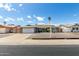 Attractive single-story home with a well-kept lawn, a two-car garage, and a charming seating area in the front yard at 3425 W Acoma Dr, Phoenix, AZ 85053
