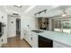 Updated kitchen featuring white cabinets and a breakfast bar open to the living area at 3425 W Acoma Dr, Phoenix, AZ 85053