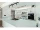 Kitchen with white cabinets, a breakfast bar, and stainless steel appliances at 3425 W Acoma Dr, Phoenix, AZ 85053