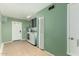 Functional laundry room featuring green walls, washer, dryer, and storage space at 3425 W Acoma Dr, Phoenix, AZ 85053