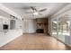 Open living area boasts tile flooring, a brick fireplace, and seamless access to the kitchen and outdoor patio at 3425 W Acoma Dr, Phoenix, AZ 85053