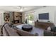Cozy living room with a brick fireplace, sliding glass doors, and a comfortable couch at 3425 W Acoma Dr, Phoenix, AZ 85053