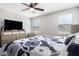 Spacious bedroom with large TV, dresser and window coverings at 25677 W Siesta Way, Buckeye, AZ 85326