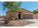 Tan house with brown garage door and landscaping at 25677 W Siesta Way, Buckeye, AZ 85326