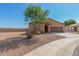 Tan house with brown garage door and landscaping at 25677 W Siesta Way, Buckeye, AZ 85326
