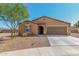 Tan house with brown garage door and landscaping at 25677 W Siesta Way, Buckeye, AZ 85326