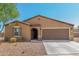 Tan house with brown garage door and landscaping at 25677 W Siesta Way, Buckeye, AZ 85326