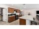 Modern kitchen with island, stainless steel appliances, and pantry at 25677 W Siesta Way, Buckeye, AZ 85326