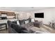 Open concept living room with kitchen view and sectional sofa at 25677 W Siesta Way, Buckeye, AZ 85326