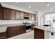 Modern kitchen with granite countertops and dark wood cabinets at 5329 W Rainwater Dr, Laveen, AZ 85339