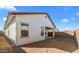 Side view of backyard, featuring a covered patio and privacy wall at 7552 W Park St, Laveen, AZ 85339