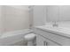 Bathroom featuring a shower-over-tub with marble tiling and a modern sink at 7552 W Park St, Laveen, AZ 85339