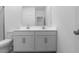Bright bathroom featuring a double vanity with modern fixtures and a toilet at 7552 W Park St, Laveen, AZ 85339