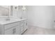 Bathroom featuring double sinks, vanity cabinets, and updated lighting fixtures at 7552 W Park St, Laveen, AZ 85339
