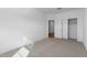 Bedroom with a sliding closet door and neutral carpet and paint at 7552 W Park St, Laveen, AZ 85339