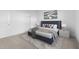Primary bedroom with a large bed, soft carpet, and minimalist artwork at 7552 W Park St, Laveen, AZ 85339