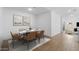A dining area with a marble table set for six, complemented by modern artwork at 7552 W Park St, Laveen, AZ 85339