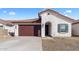 Charming single-story home features a well-manicured yard, brown tile roof and an attached two-car garage at 7552 W Park St, Laveen, AZ 85339