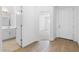Hallway featuring a bathroom entrance and a front door with wood-look flooring at 7552 W Park St, Laveen, AZ 85339