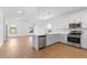 A kitchen with stainless steel appliances, a large island, white cabinets, and tile backsplash at 7552 W Park St, Laveen, AZ 85339