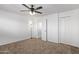 Empty bedroom with neutral carpet, ceiling fan, white walls, and closet at 728 W Grove Cir, Mesa, AZ 85210