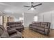 Bright living room with ceiling fan and hardwood floors, illuminated by natural light at 728 W Grove Cir, Mesa, AZ 85210