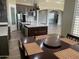 Modern kitchen with island, stainless steel appliances, and hardwood floors at 29923 W Melvin St, Buckeye, AZ 85396