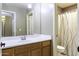 Bathroom featuring wood vanity, framed mirror, and shower/tub combination with curtain at 786 W Jahns Dr, Casa Grande, AZ 85122