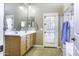 Bright primary bathroom with double vanity, tiled floors, and a shower with glass door at 786 W Jahns Dr, Casa Grande, AZ 85122