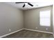 Neutral bedroom features modern ceiling fan, plush carpeting, and bright window with natural light at 786 W Jahns Dr, Casa Grande, AZ 85122